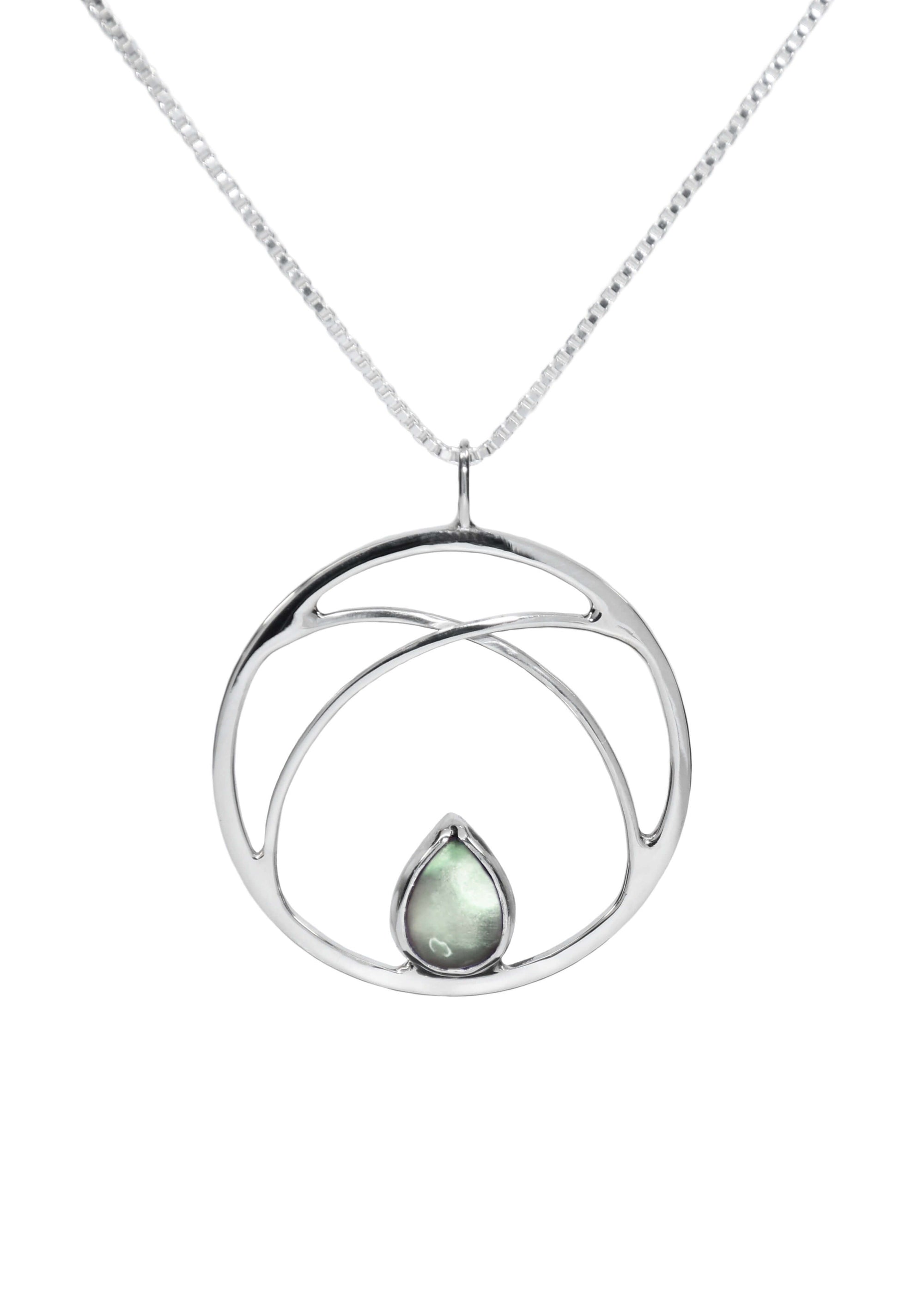 A handmade sterling silver necklace with circle pendant and green amethyst