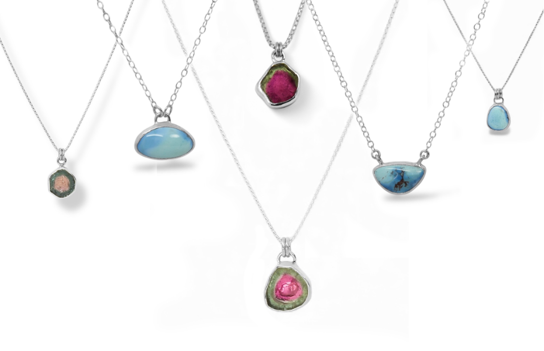 Set of necklaces with colorful gemstone pendants on a white background