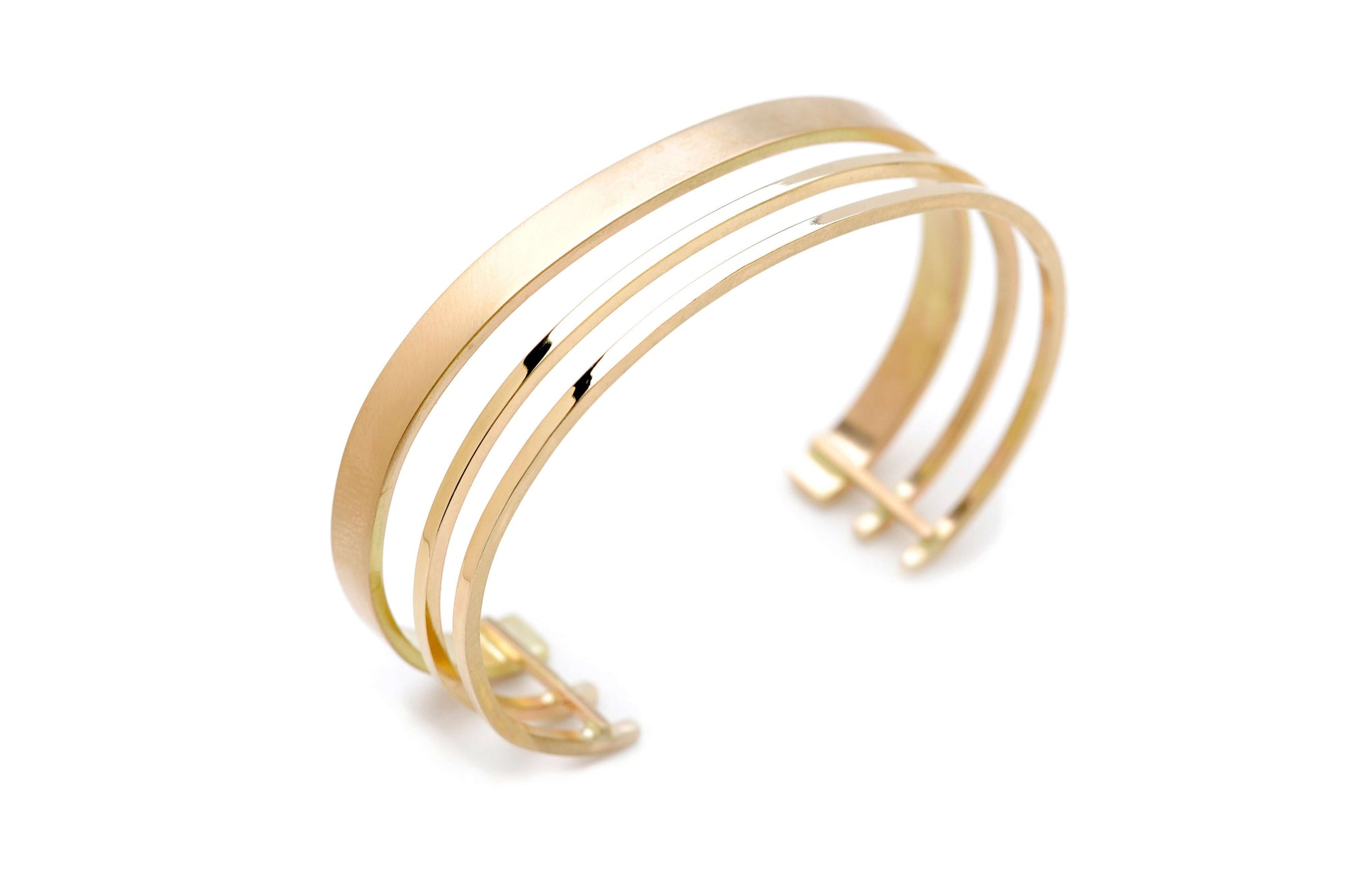 A triple band 14k gold cuff bracelet