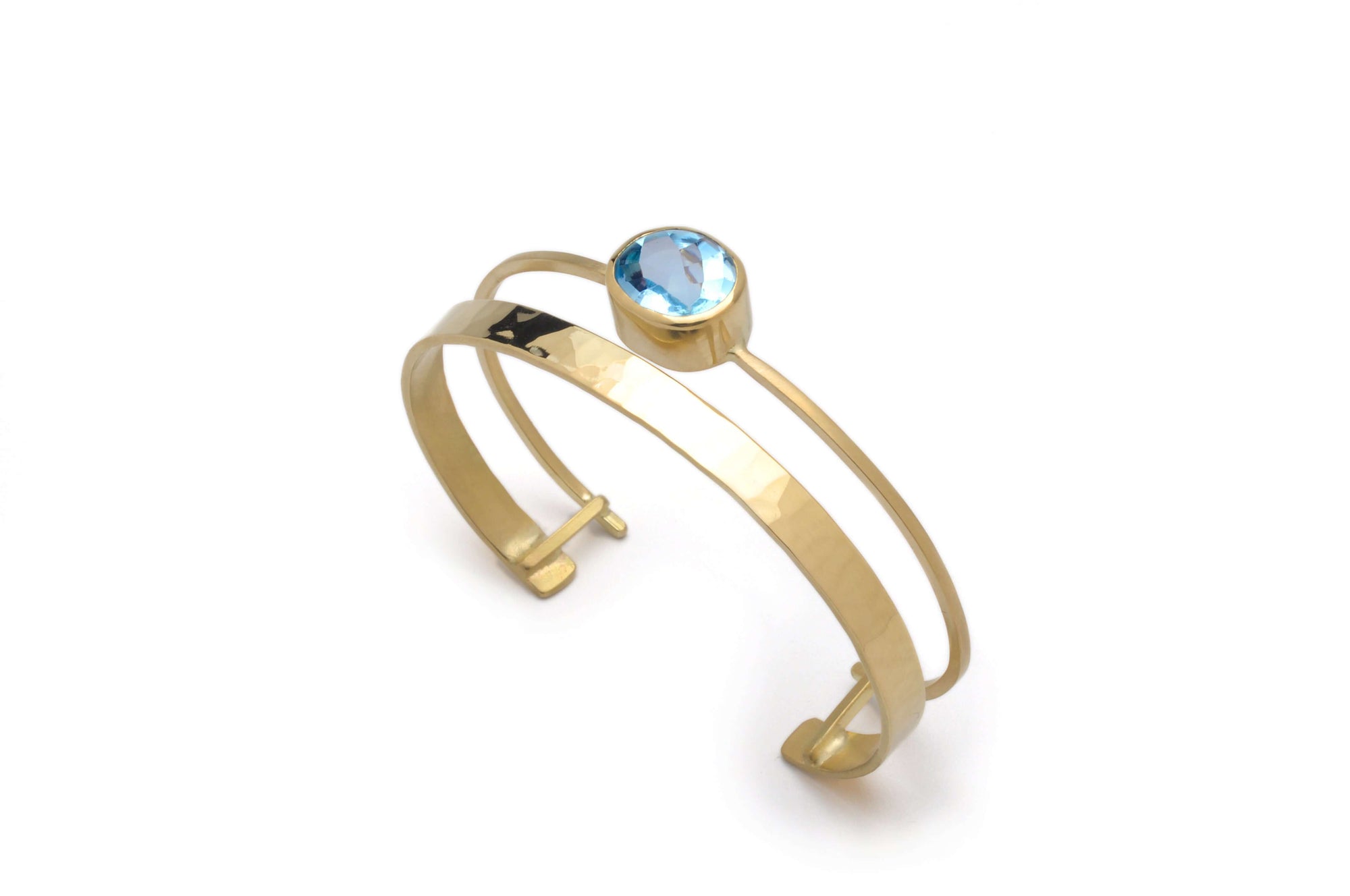 A 18k gold cuff bracelet with sky blue topaz