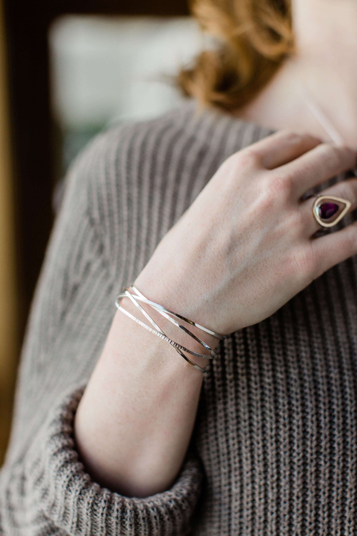 A model wears our handmade 4-band sterling silver woven bracelet