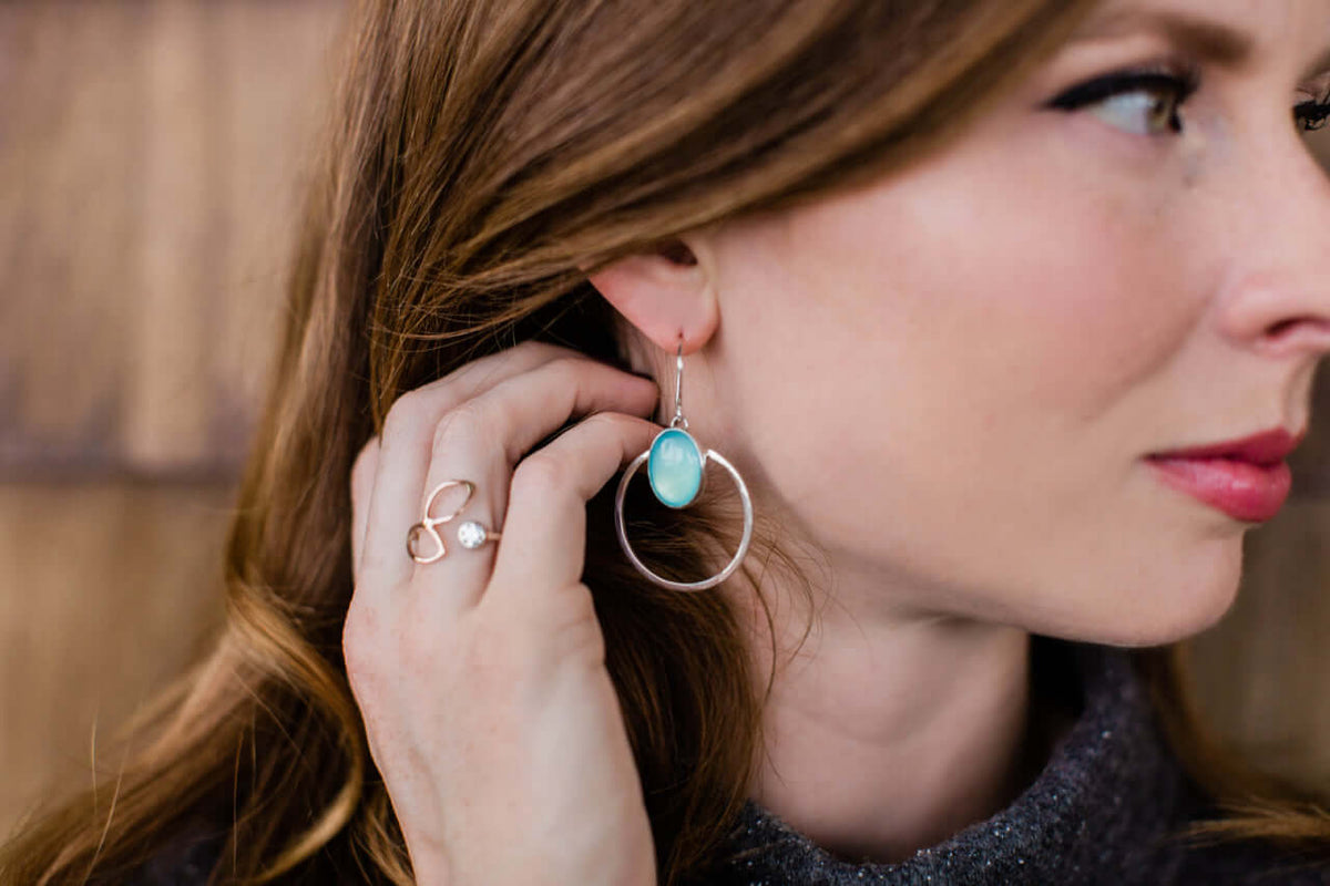 A model wears sterling silver and blue agate earrings