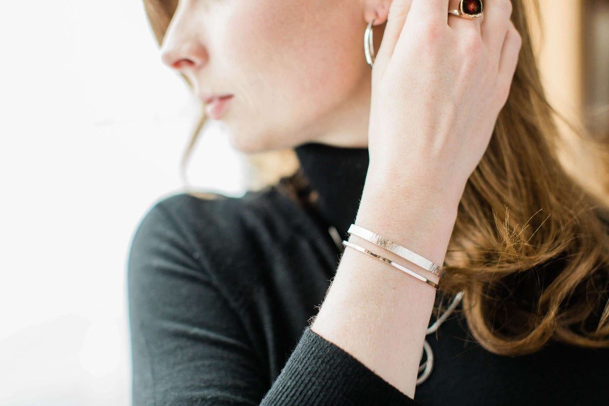 A model wears a hammered cuff bracelet