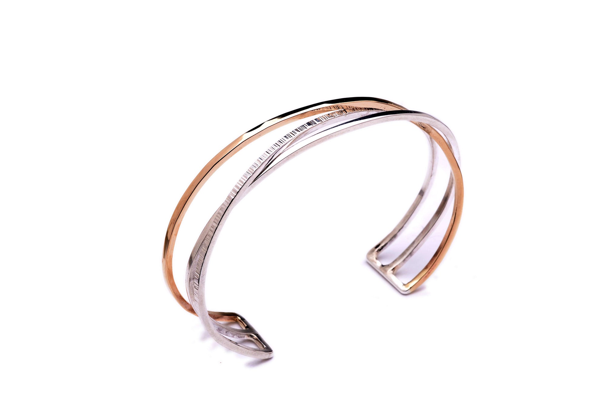 A mixed metal gold and silver cuff bracelet