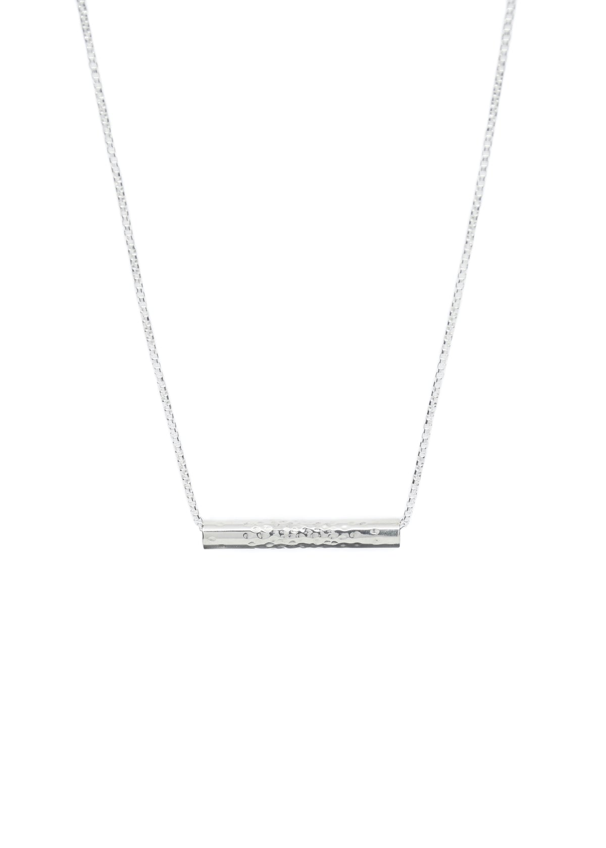 A handmade sterling silver tube necklace with dot texture on a silver chain