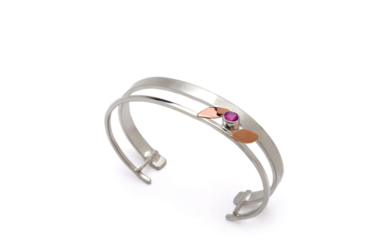 A rose gold leaf bracelet with garnet