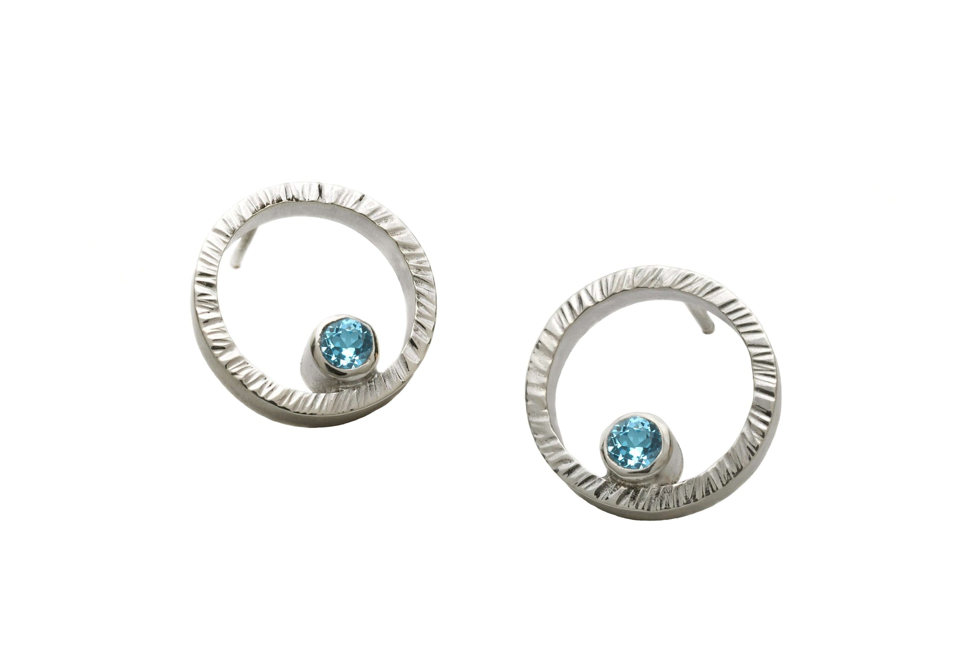 A pair of sterling silver circle studs with Swiss blue topaz