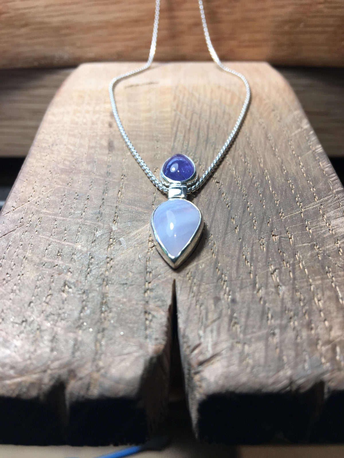 A handmade sterling silver tanzanite pendant with blue lace agate on a ...