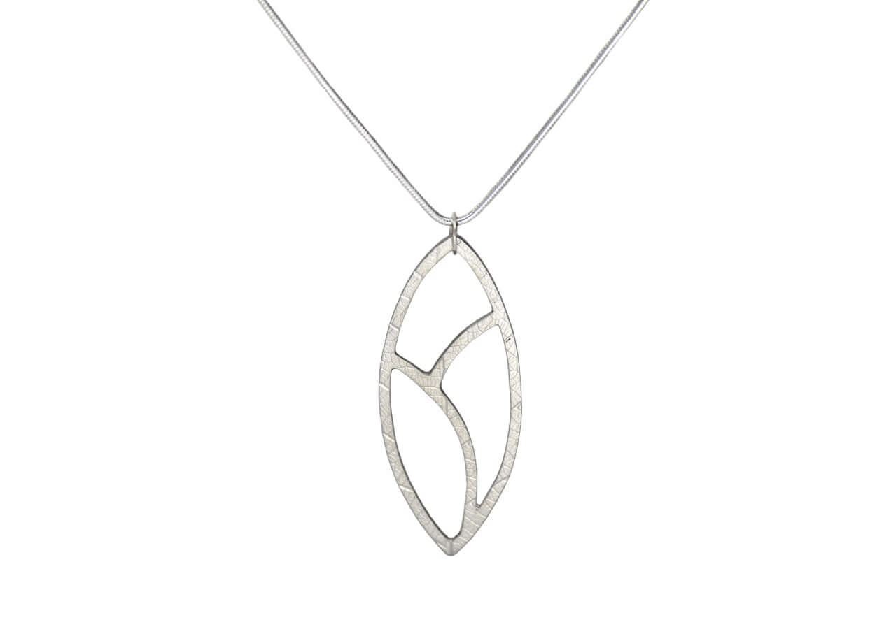A silver leaf necklace with handmade texture is shown on a silver necklace