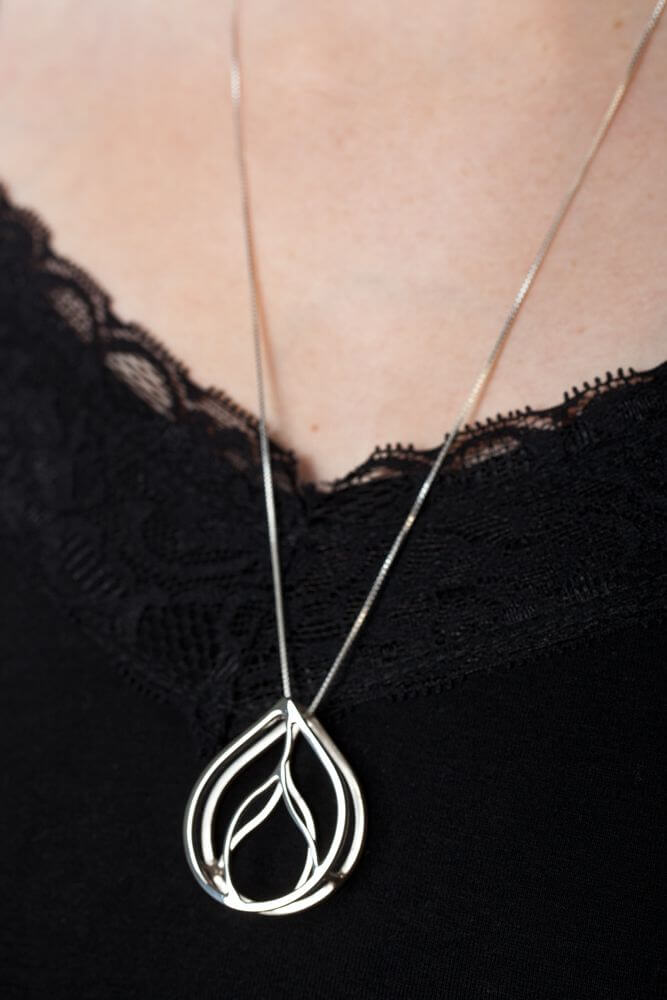 sterling silver pendulum pendant on black shirt