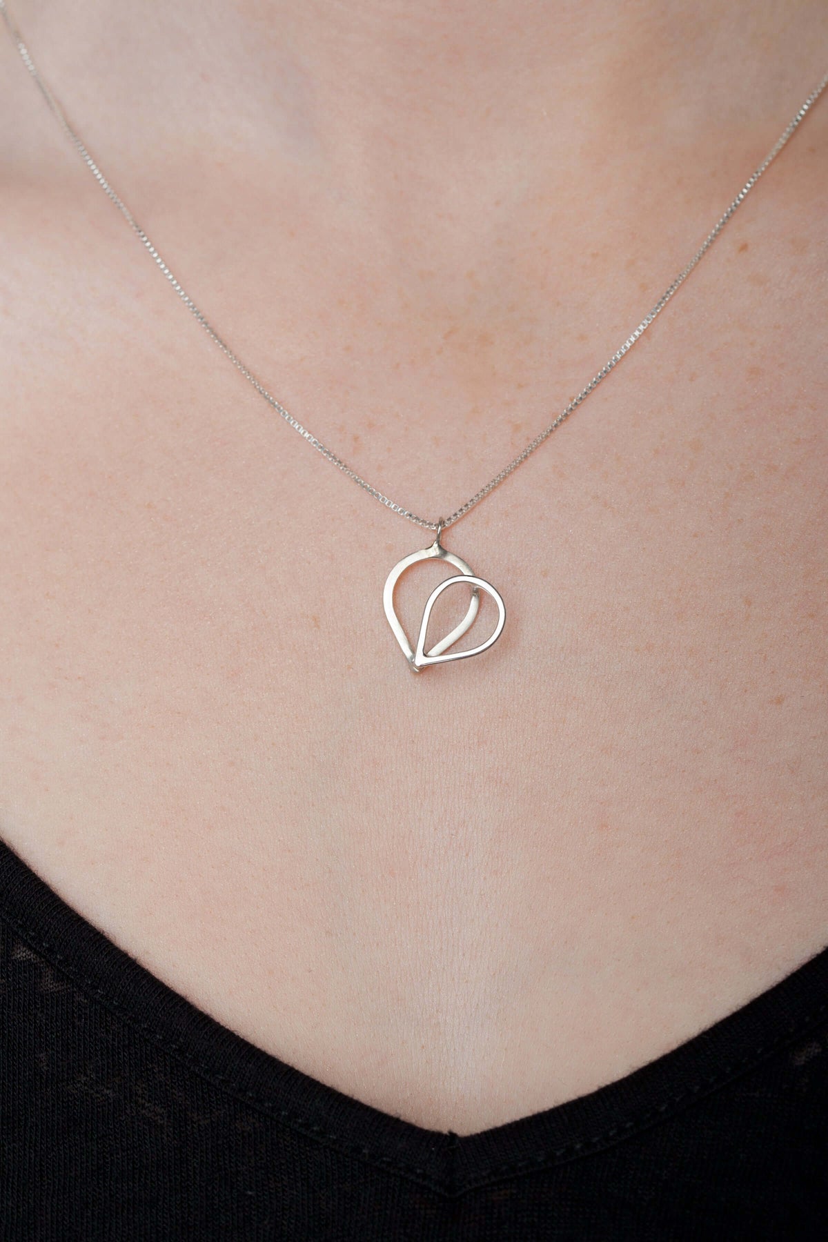 a sterling silver heart necklace with 3D design