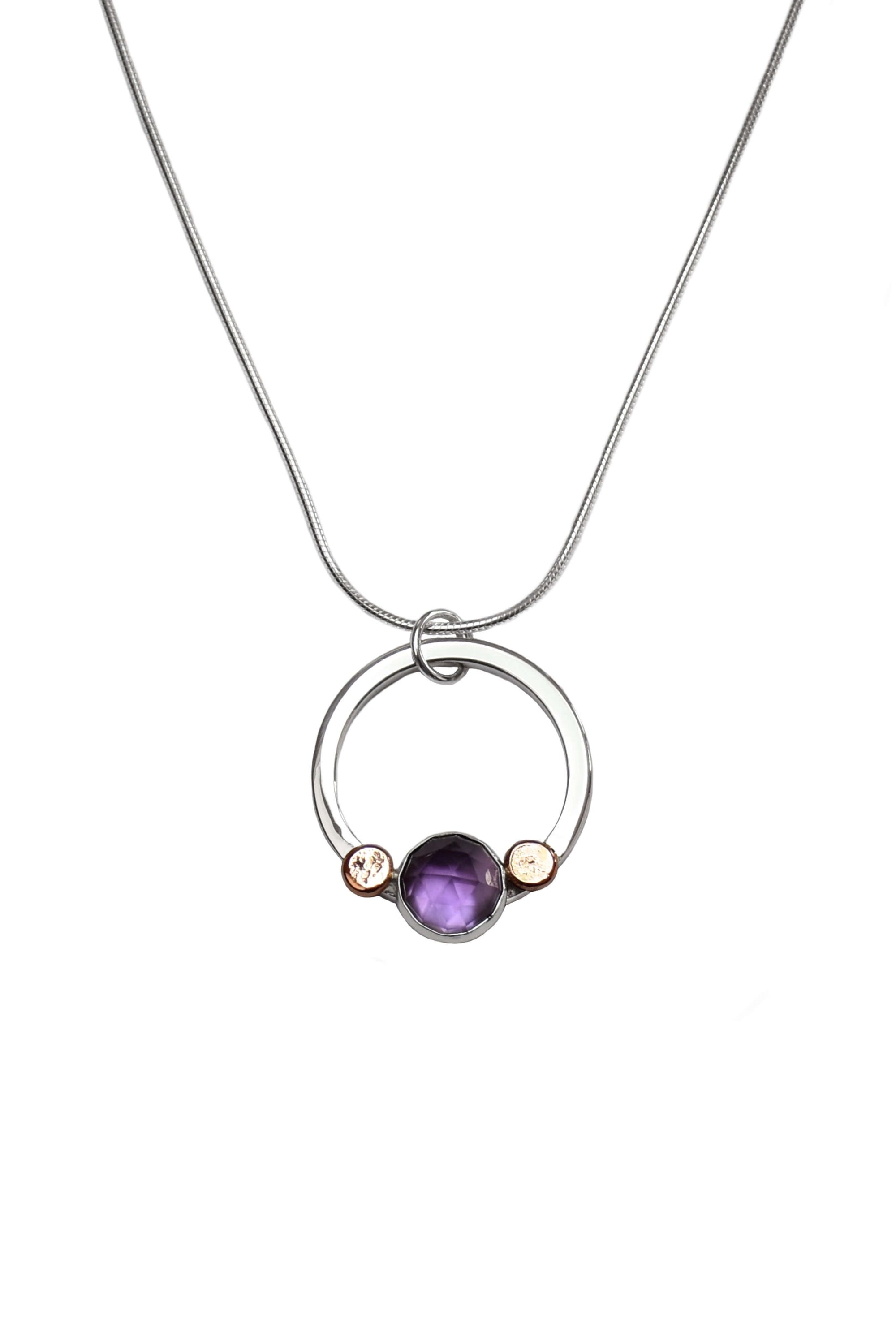 a sterling silver and amethyst necklace with rose gold pebble details