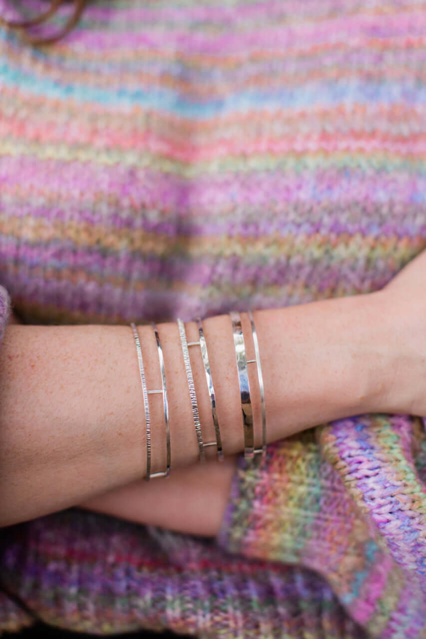 A model wears a three types of sterling silver double bangle
