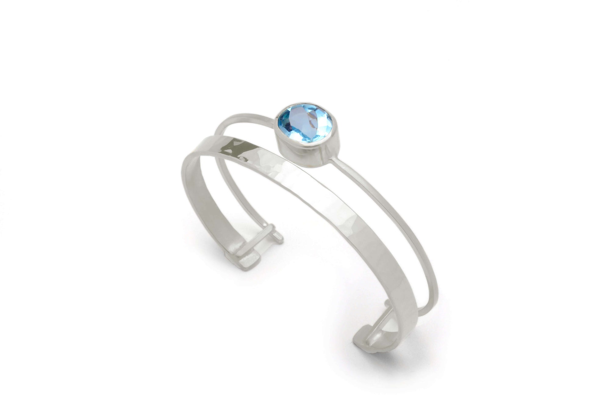 A sterling silver gemstone cuff bracelet is pictured with sky blue topaz