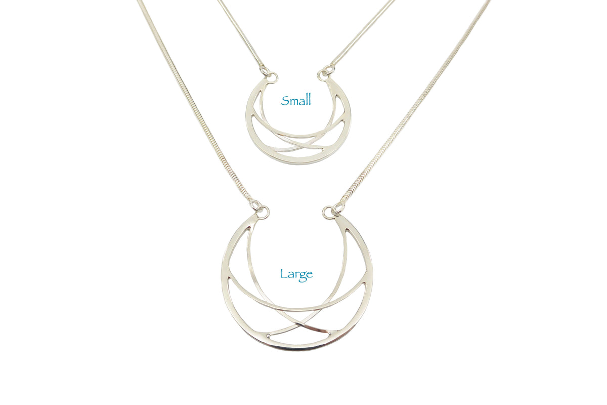 A handmade sterling silver crescent necklace in two sizes