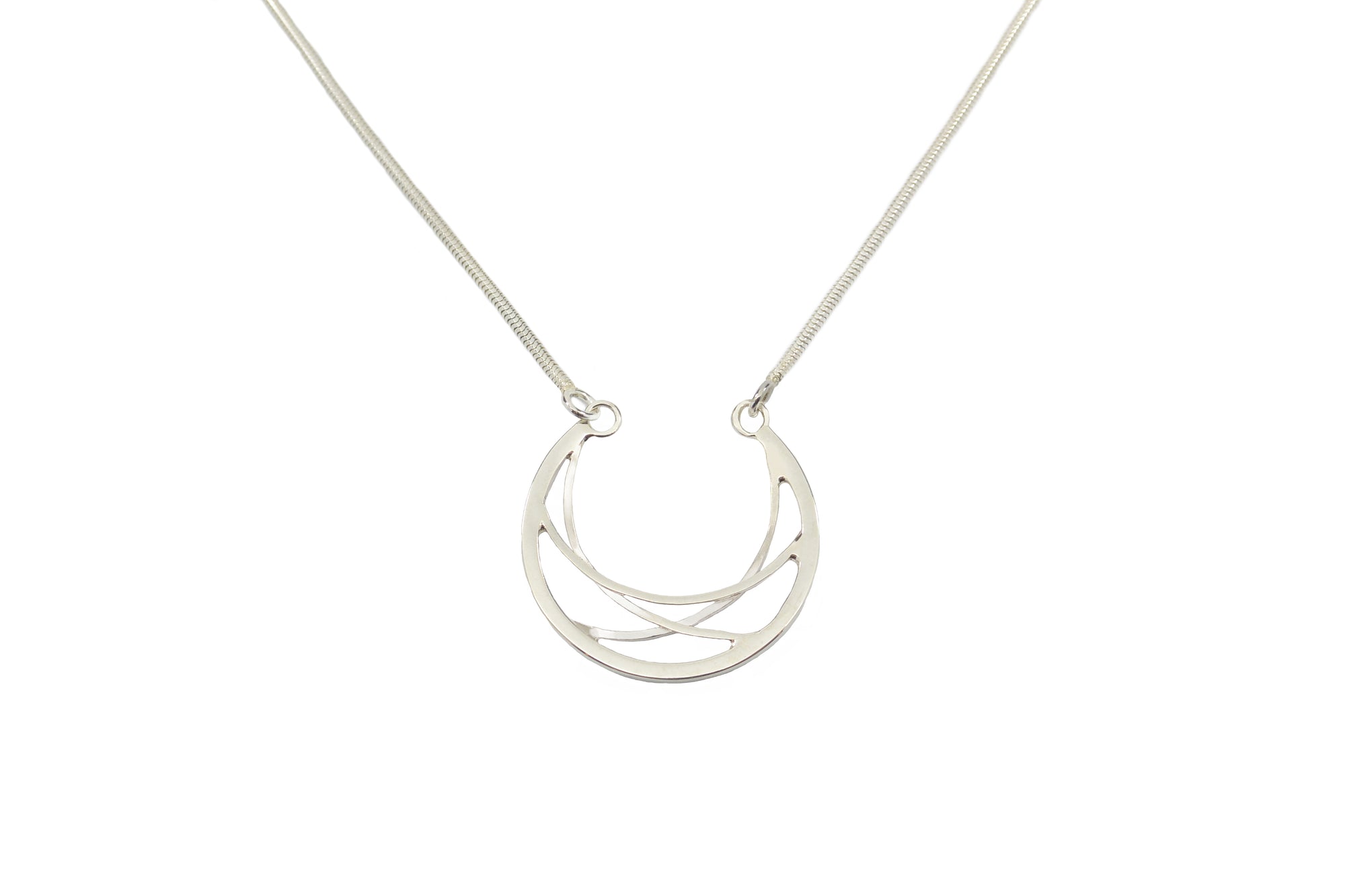 A handmade sterling silver crescent necklace on a silver chain