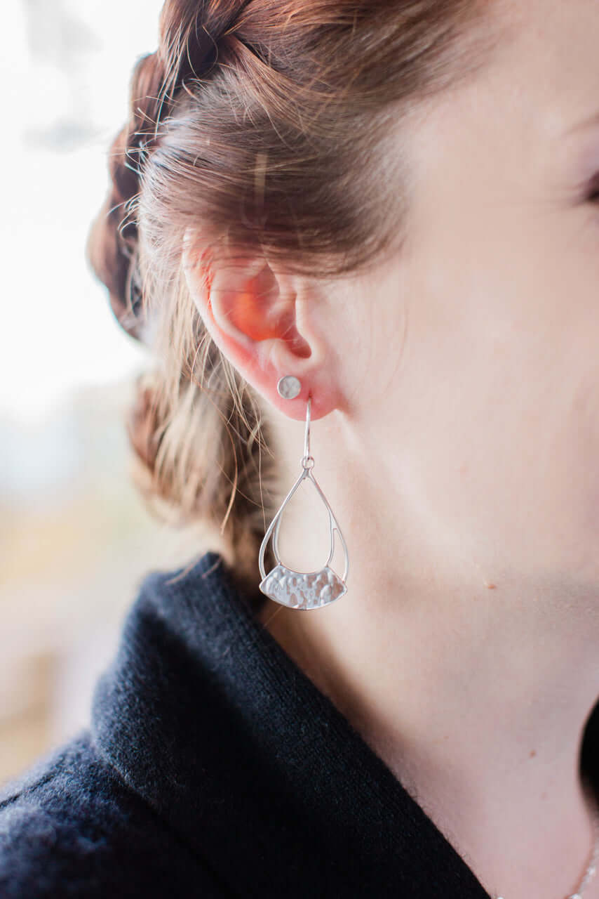 Sterling silver torc earrings are worn by a model