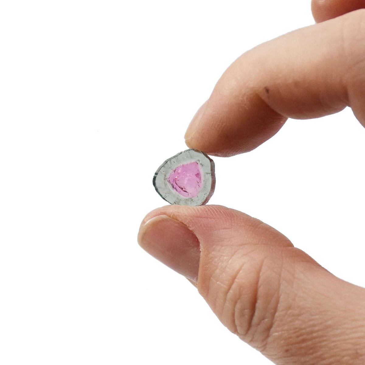 buy watermelon tourmaline slices like this one held between two fingers