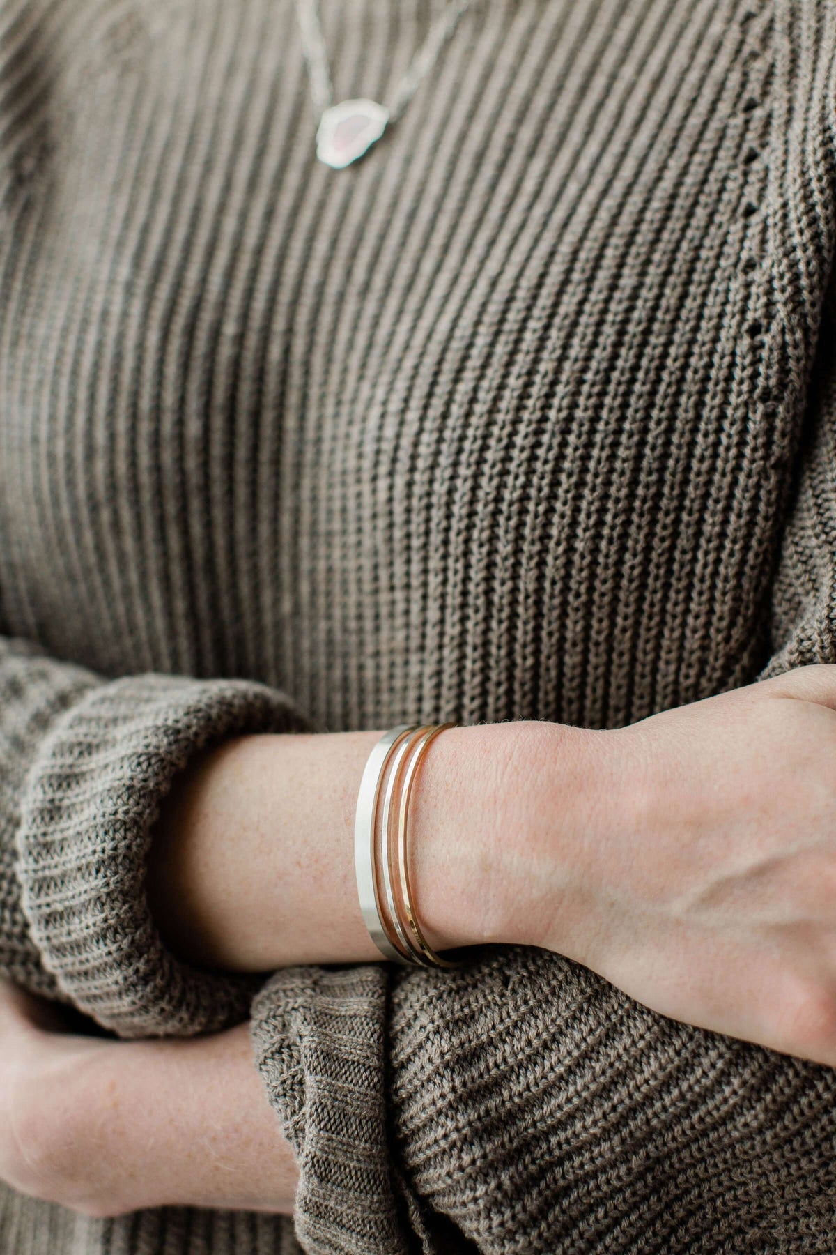 A model wears a 14k gold and silver bracelet