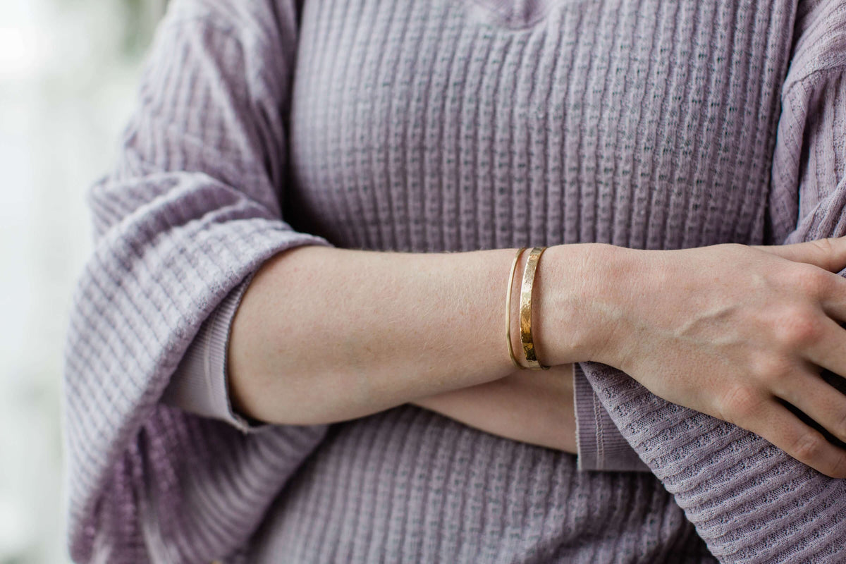 A model wears a 14k gold cuff bracelet women&#39;s