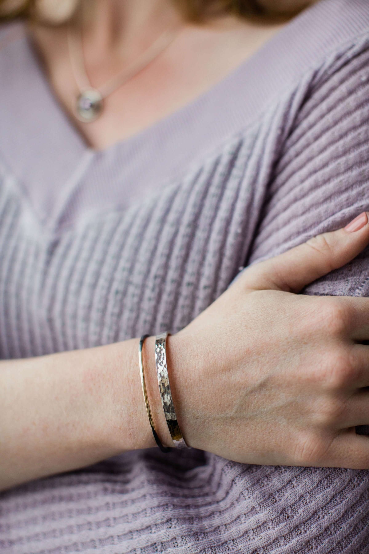 A model wears an example of oxidized silver and gold jewelry