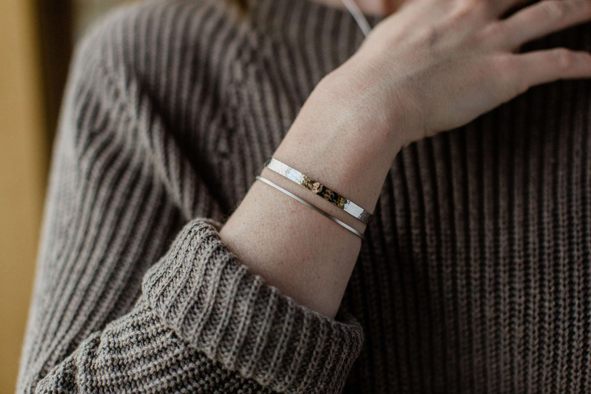 A model wears a sterling silver cuff bracelet, women&#39;s jewelry option