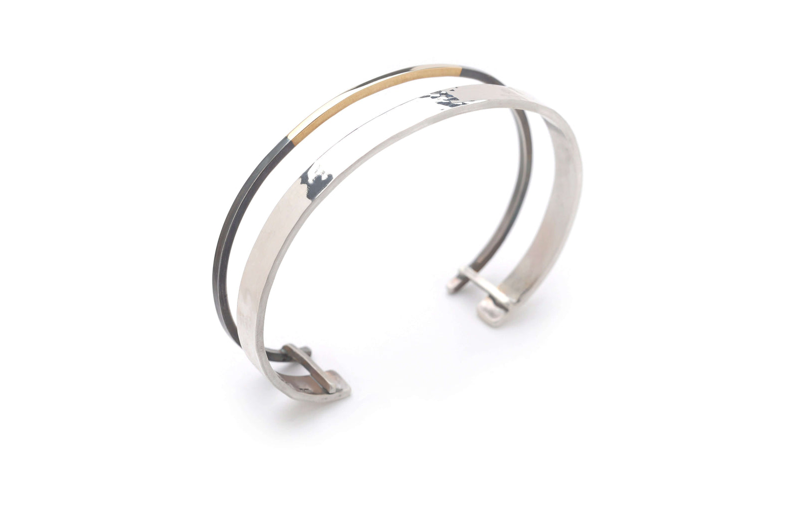 A handmade oxidized silver and gold jewelry cuff bracelet