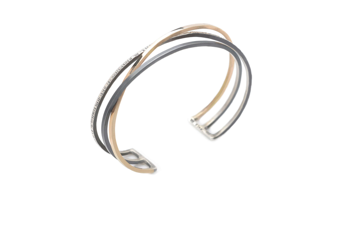 A handmade woven mixed metal cuff bracelet