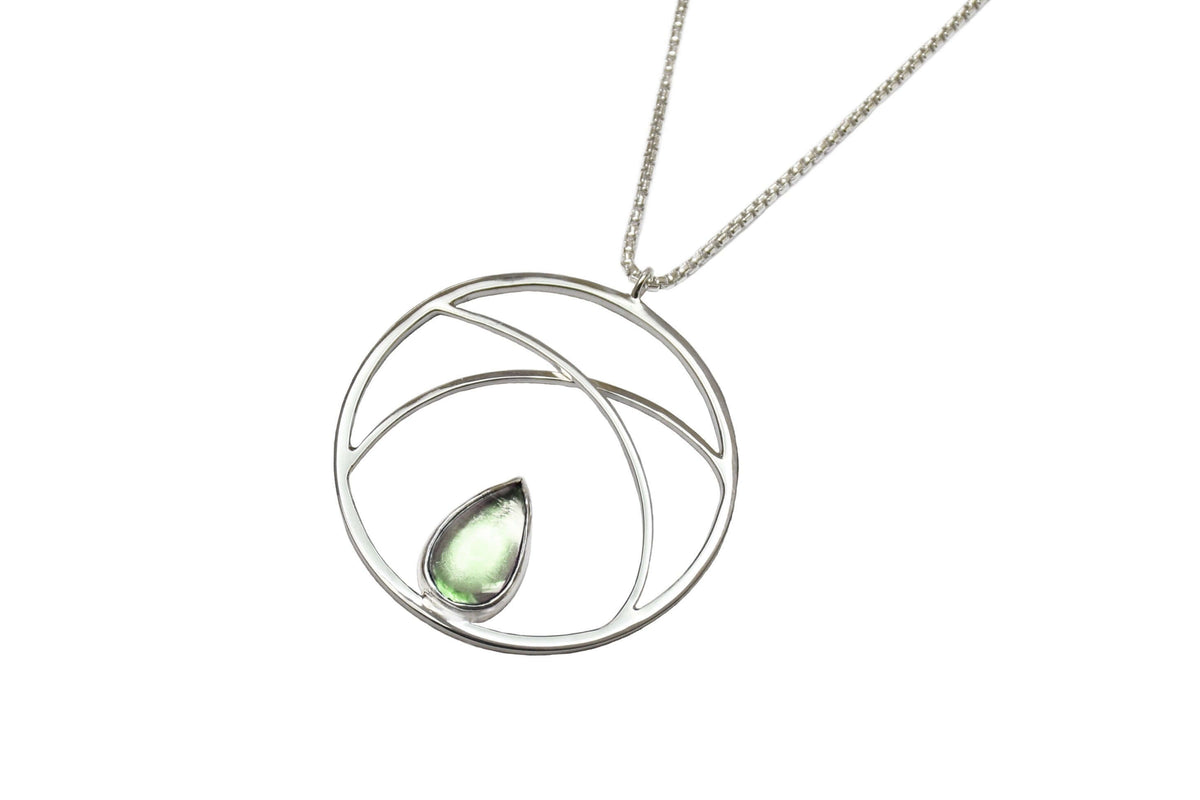 a handmade sterling silver circle pendant necklace with green amethyst