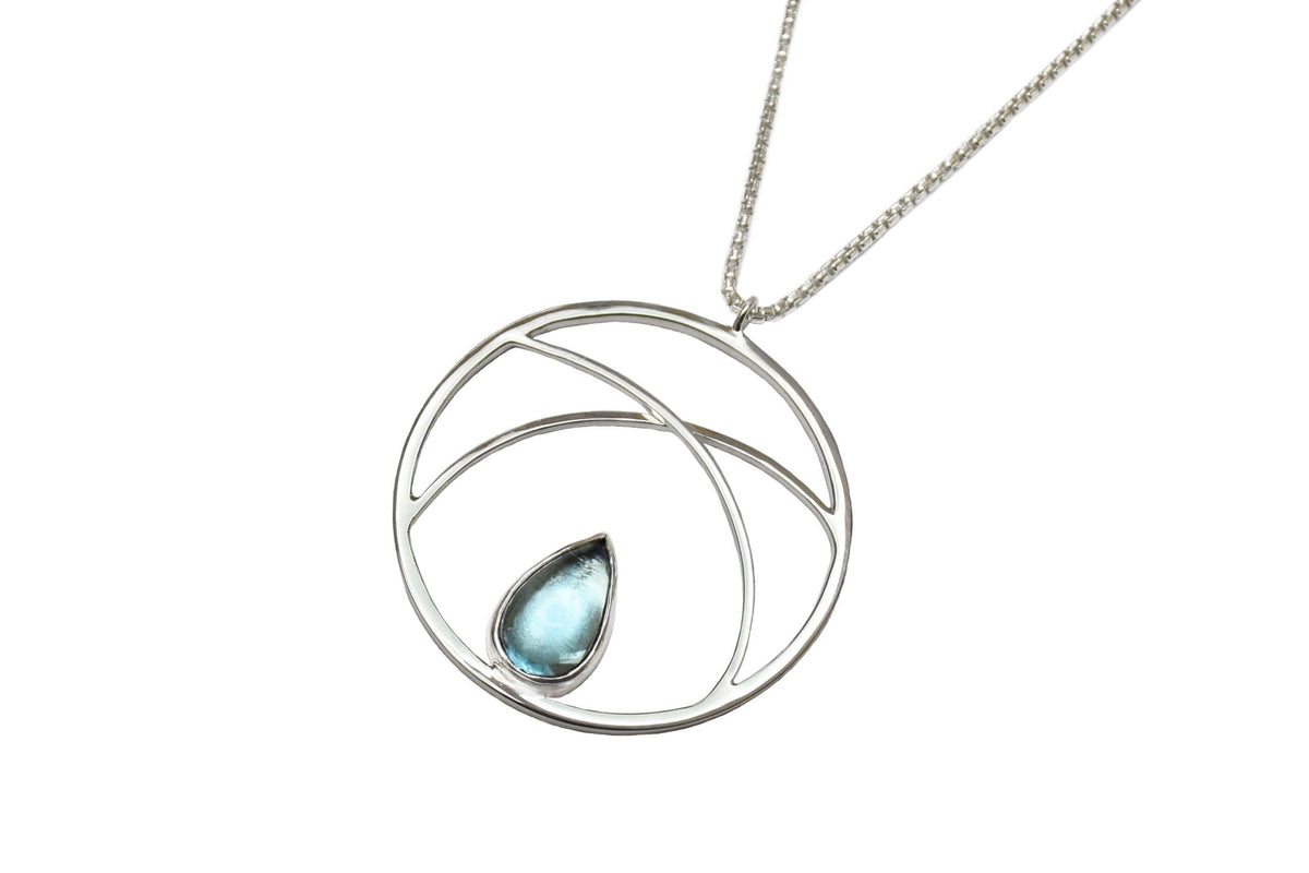 A handmade sterling silver circle pendant necklace with sky topaz