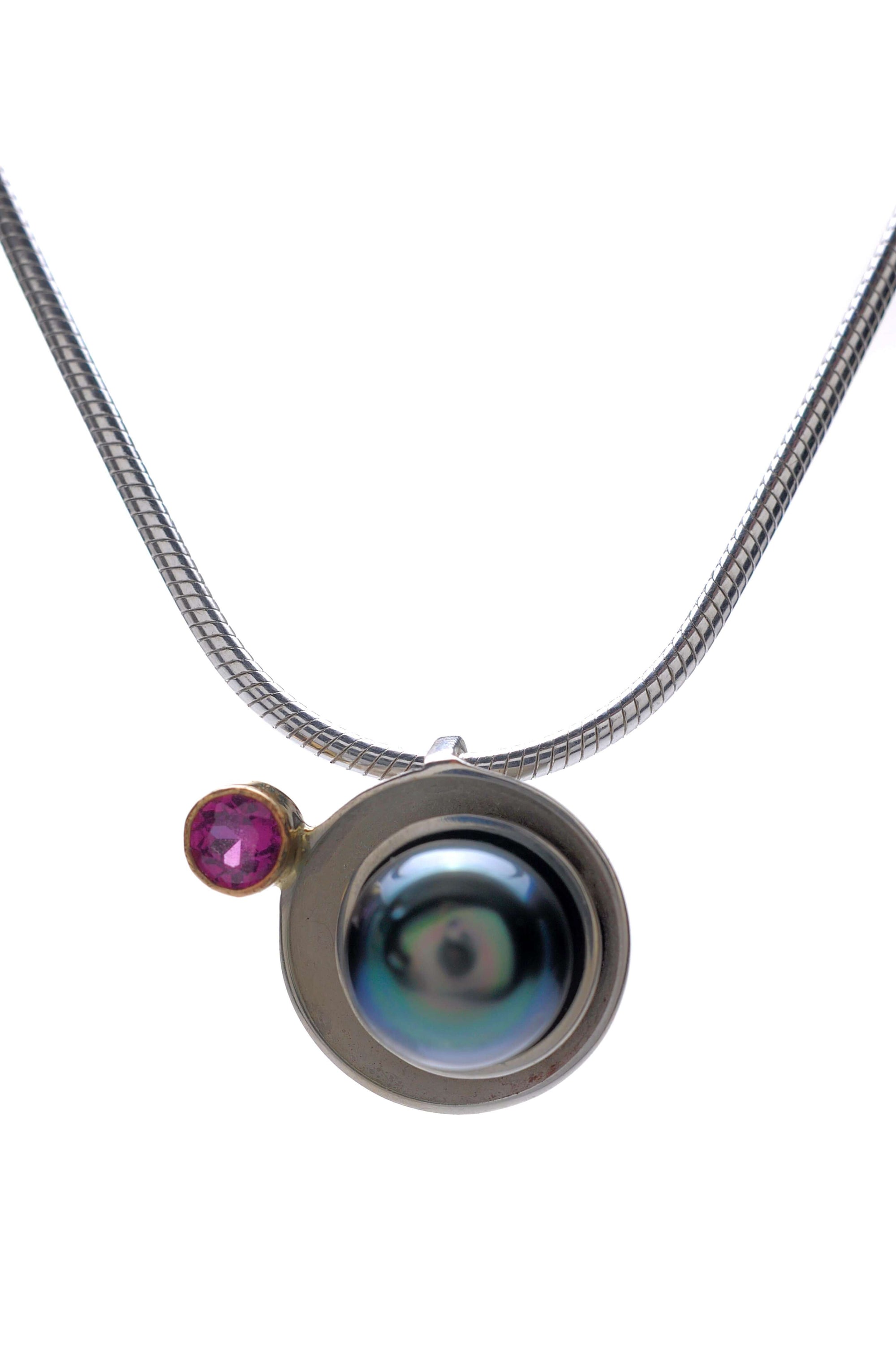 A Tahitian pearl planet pendant with garnet